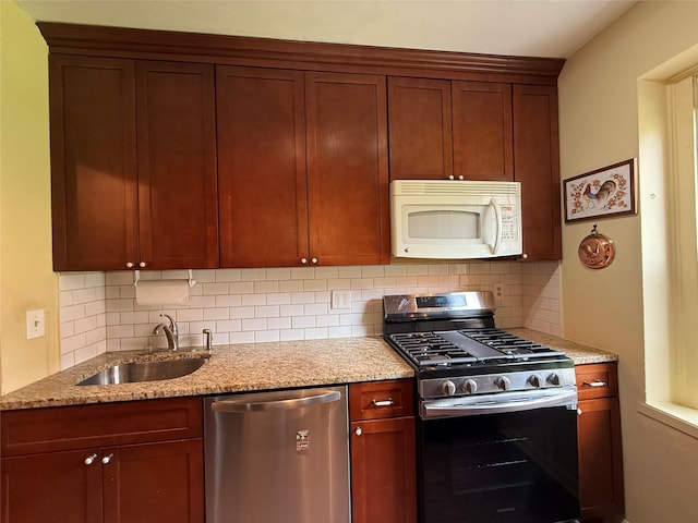 198 Garth Rd Unit 1D, Scarsdale, NY 10583 - kitchen with appliances with stainless steel finishes, a sink, decorative backsplash, and light stone counters