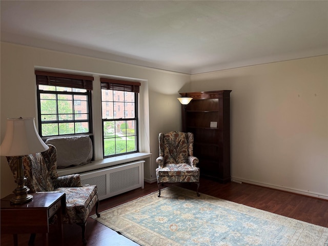 198 Garth Rd Unit 1D, Scarsdale, NY 10583 - sitting room with radiator, wood finished floors, and baseboards