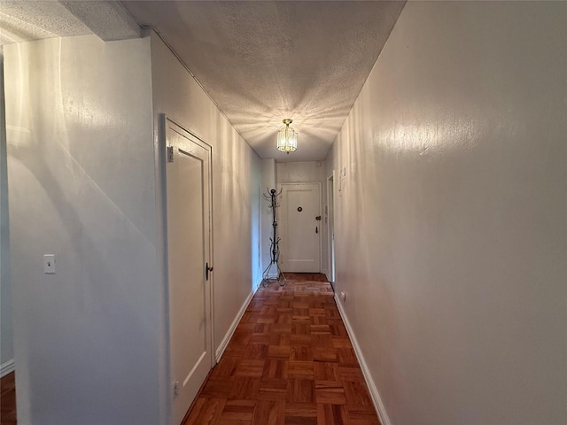 198 Garth Rd Unit 1D, Scarsdale, NY 10583 - hall featuring a textured ceiling and baseboards