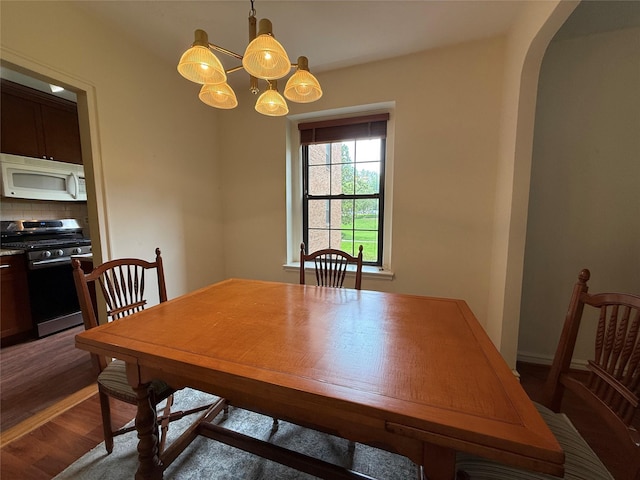 198 Garth Rd Unit 1D, Scarsdale, NY 10583 - dining room with wood finished floors, a chandelier, and arched walkways
