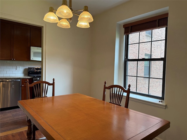 198 Garth Rd Unit 1D, Scarsdale, NY 10583 - dining space featuring a chandelier and dark wood finished floors
