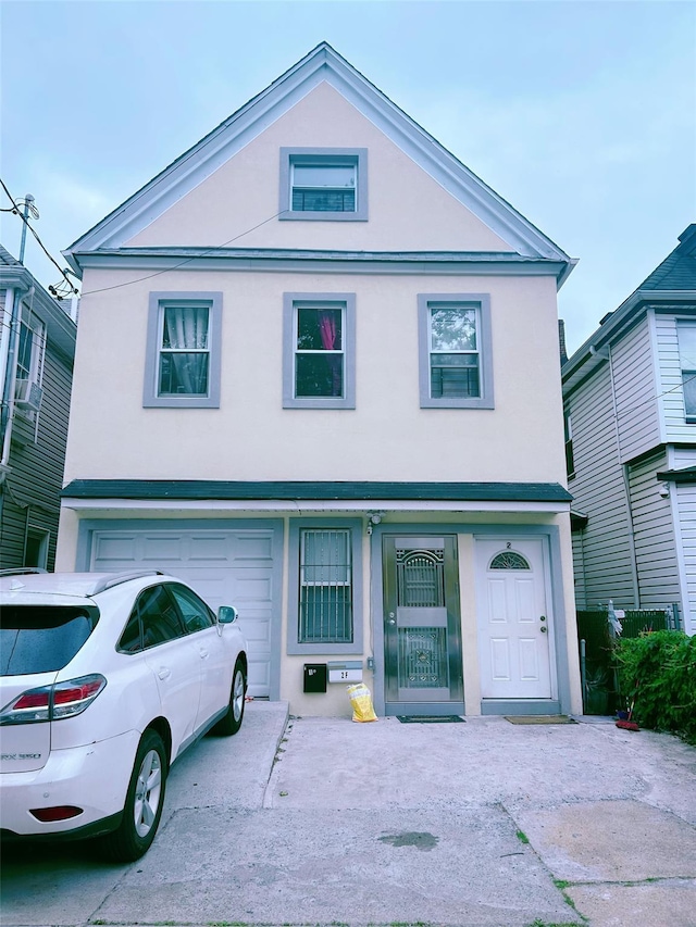 94-30 50th Ave, Elmhurst, NY 11373 - view of front facade featuring stucco siding, an attached garage, and driveway