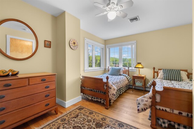 138 Jansen, Holmes, NY 12531 - bedroom with light wood-style floors, baseboard heating, and ceiling fan