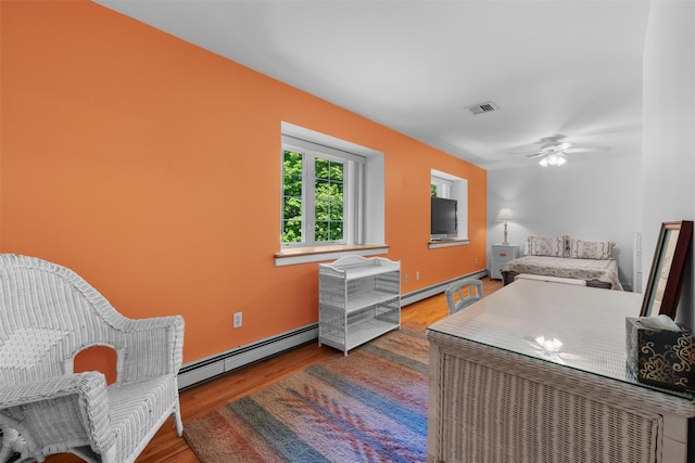 138 Jansen, Holmes, NY 12531 - bedroom featuring baseboard heating, wood finished floors, and a ceiling fan