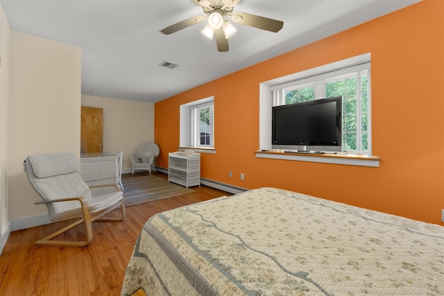 138 Jansen, Holmes, NY 12531 - bedroom with baseboard heating, a baseboard radiator, wood finished floors, and a ceiling fan