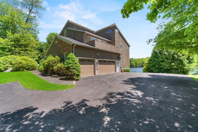 138 Jansen, Holmes, NY 12531 - view of side of property with a balcony, asphalt driveway, and an attached garage