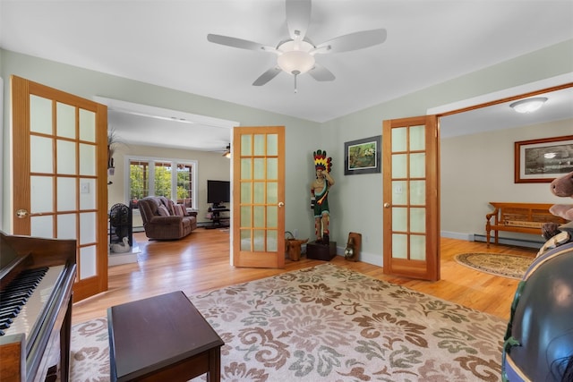 138 Jansen, Holmes, NY 12531 - living area with french doors, a ceiling fan, wood finished floors, and baseboard heating