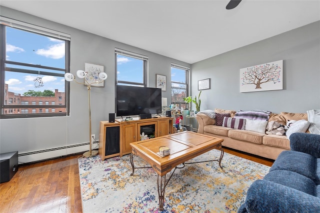 1 Jefferson Ave Unit B12, Rockville Centre, NY 11570 - living area featuring a baseboard radiator and wood finished floors