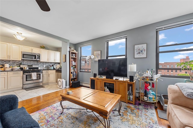 1 Jefferson Ave Unit B12, Rockville Centre, NY 11570 - living room featuring a baseboard heating unit, light wood-type flooring, and ceiling fan