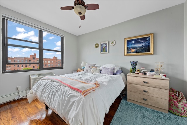 1 Jefferson Ave Unit B12, Rockville Centre, NY 11570 - bedroom featuring wood finished floors, ceiling fan, a baseboard heating unit, and a wall mounted AC