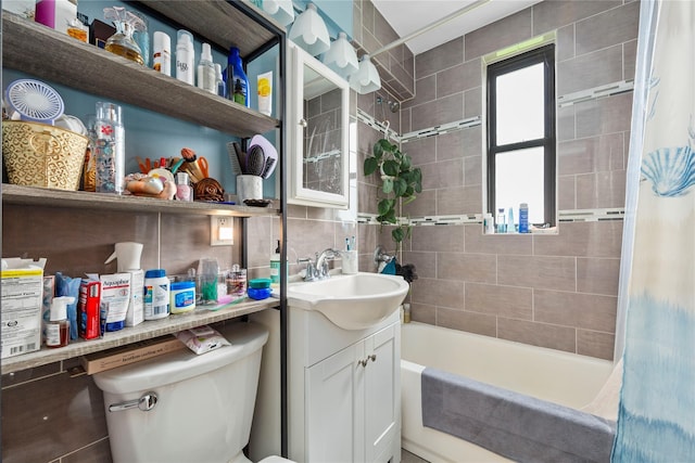 1 Jefferson Ave Unit B12, Rockville Centre, NY 11570 - bathroom featuring vanity, toilet, shower / bath combination with curtain, tasteful backsplash, and tile walls