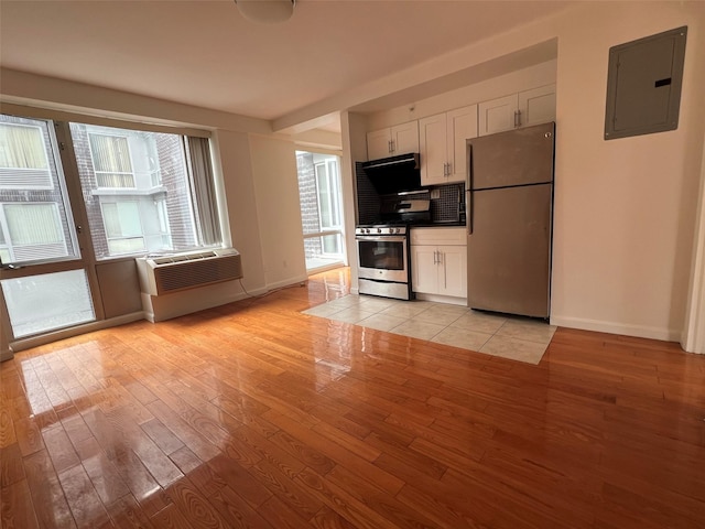 139-30 34th Ave Unit 3B, Flushing, NY 11355 - kitchen with stainless steel appliances, electric panel, light wood finished floors, and white cabinets