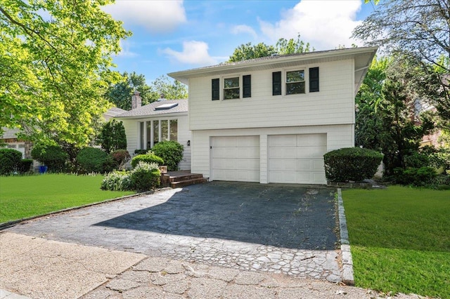 311 Hungry Harbor Rd, North Woodmere, NY 11581 - tri-level home with driveway, an attached garage, a front lawn, and a chimney