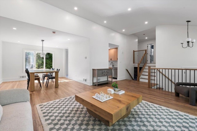 311 Hungry Harbor Rd, North Woodmere, NY 11581 - living area featuring light wood-style floors, a chandelier, recessed lighting, baseboards, and stairway
