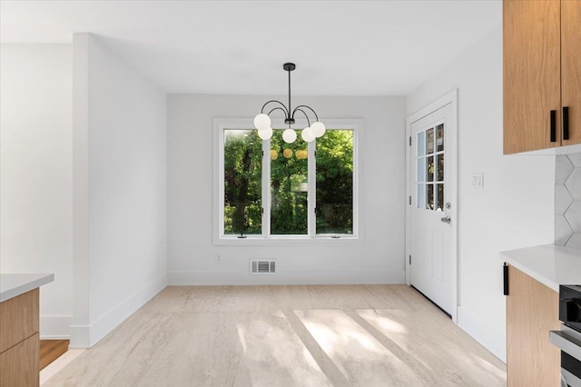 311 Hungry Harbor Rd, North Woodmere, NY 11581 - unfurnished dining area with a chandelier and baseboards