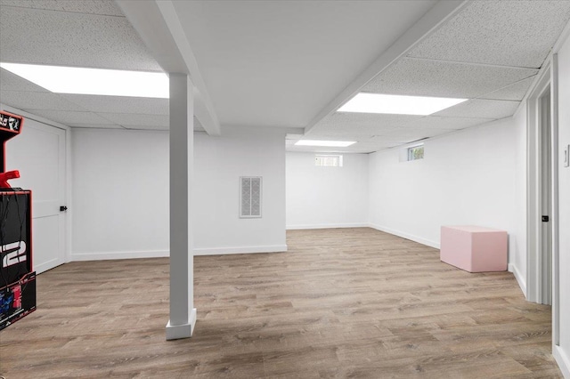 311 Hungry Harbor Rd, North Woodmere, NY 11581 - basement with a paneled ceiling, wood finished floors, and baseboards