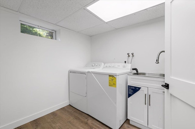 311 Hungry Harbor Rd, North Woodmere, NY 11581 - washroom with cabinet space, washer and clothes dryer, wood finished floors, and baseboards