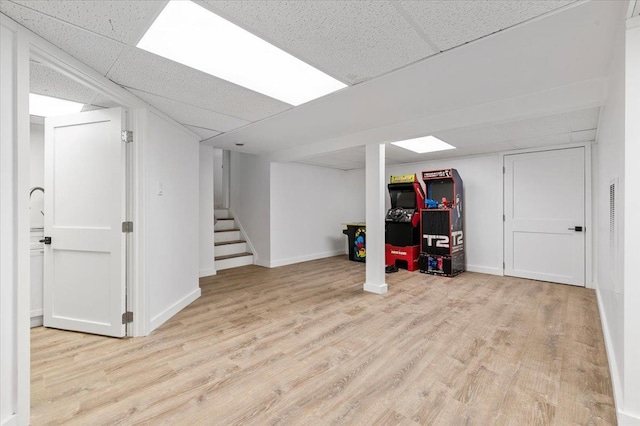 311 Hungry Harbor Rd, North Woodmere, NY 11581 - finished below grade area with wood finished floors, a drop ceiling, stairs, and baseboards