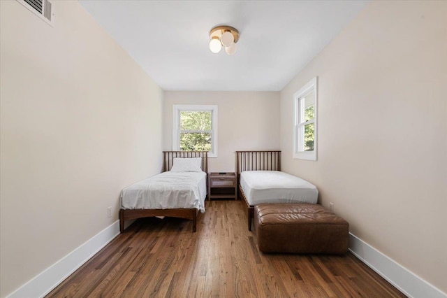 311 Hungry Harbor Rd, North Woodmere, NY 11581 - bedroom with baseboards and wood finished floors