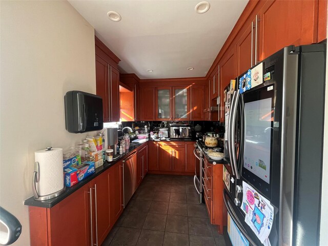 167-11 Powells Cove Blvd Unit 27, Beechhurst, NY 11357 - kitchen with stainless steel appliances, dark countertops, dark tile patterned flooring, a sink, and recessed lighting