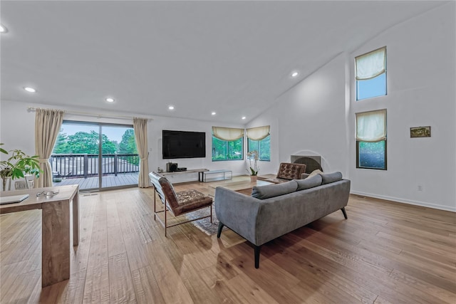 291 Starling Ct, Manhasset, NY 11030 - living area featuring wood-type flooring, recessed lighting, a towering ceiling, and baseboards