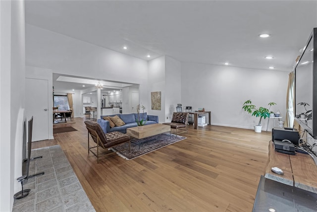 291 Starling Ct, Manhasset, NY 11030 - living area featuring light wood-style floors, recessed lighting, a towering ceiling, and baseboards