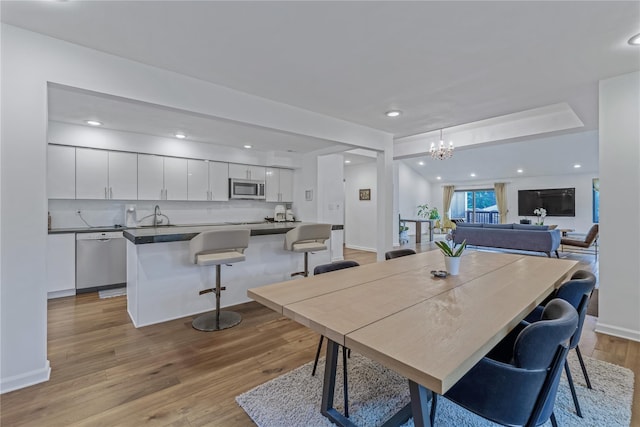 291 Starling Ct, Manhasset, NY 11030 - dining area featuring light wood finished floors, a chandelier, recessed lighting, and baseboards