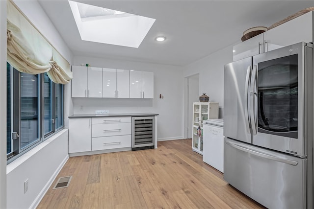 291 Starling Ct, Manhasset, NY 11030 - kitchen featuring smart refrigerator, wine cooler, white cabinetry, baseboards, and recessed lighting