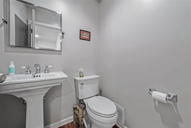 291 Starling Ct, Manhasset, NY 11030 - half bath featuring baseboards, toilet, and wood finished floors