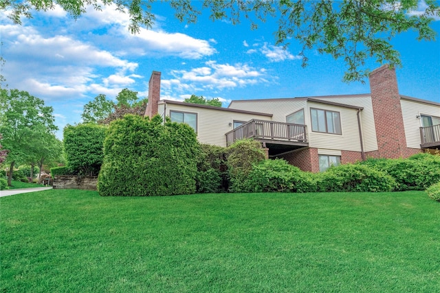 291 Starling Ct, Manhasset, NY 11030 - rear view of house featuring a chimney and a lawn