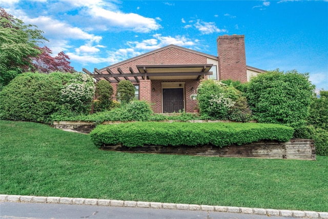 291 Starling Ct, Manhasset, NY 11030 - view of front of home featuring brick siding, a front lawn, and a chimney