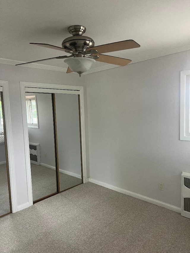 274 Edmunton Dr Unit K8, North Babylon, NY 11703 - unfurnished bedroom featuring carpet, ornamental molding, a ceiling fan, baseboards, and multiple closets