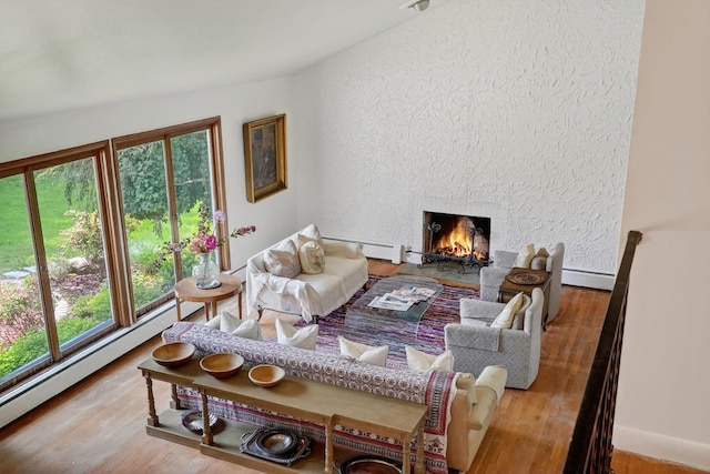 35 Old Farms Rd, Poughkeepsie, NY 12603 - living room with a baseboard radiator, wood finished floors, a lit fireplace, and a textured wall