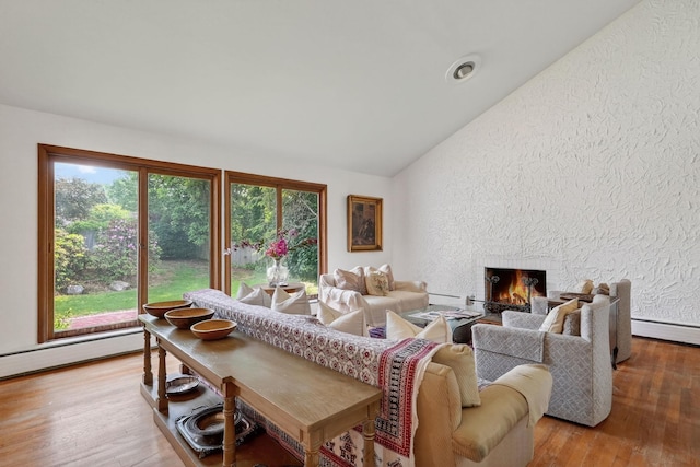 35 Old Farms Rd, Poughkeepsie, NY 12603 - living room featuring a textured wall, lofted ceiling, a large fireplace, wood finished floors, and baseboard heating