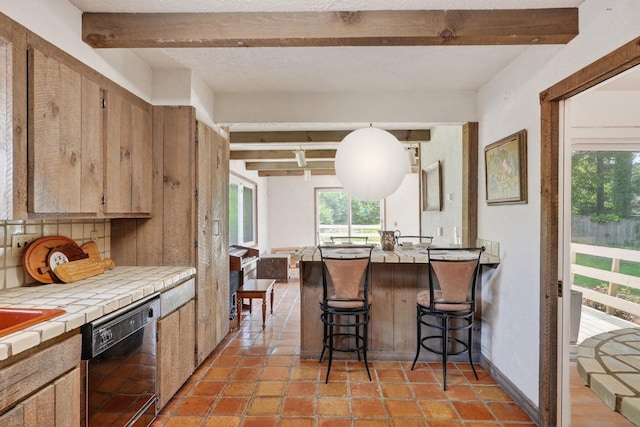 35 Old Farms Rd, Poughkeepsie, NY 12603 - kitchen with black dishwasher, tile countertops, beamed ceiling, a breakfast bar, and a peninsula