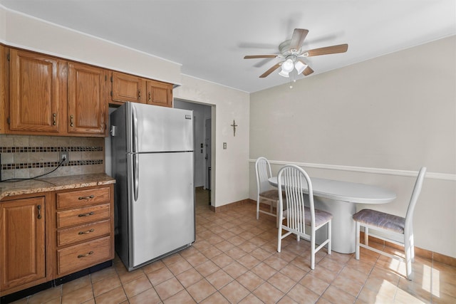 4 Leewood Cir Unit 4L, Eastchester, NY 10709 - kitchen with freestanding refrigerator, a ceiling fan, brown cabinetry, and tasteful backsplash