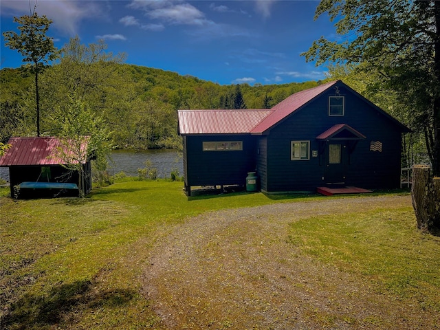 110 Lake Muskoday Rd, Roscoe, NY 12736 - chalet / cabin featuring a front lawn, metal roof, a water view, and a view of trees
