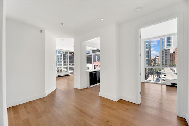 26-26 Jackson Ave Unit 402, Long Island City, NY 11101 - spare room featuring wood finished floors, baseboards, and a city view