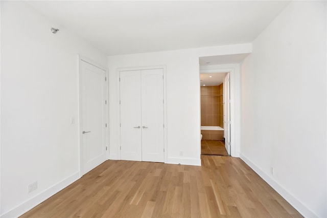26-26 Jackson Ave Unit 402, Long Island City, NY 11101 - unfurnished bedroom featuring light wood-style flooring, baseboards, and a closet