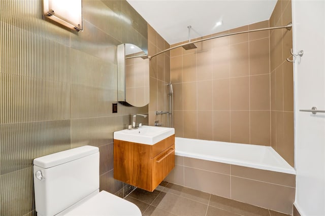 26-26 Jackson Ave Unit 402, Long Island City, NY 11101 - bathroom with tile walls, vanity, toilet, a combined bath / shower with rainfall shower, and tile patterned floors