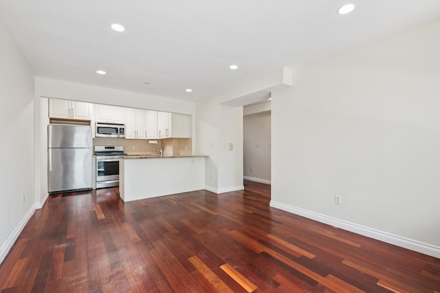 71-19 162nd St Unit 4E, Fresh Meadows, NY 11365 - kitchen featuring stainless steel appliances, decorative backsplash, baseboards, white cabinets, and recessed lighting