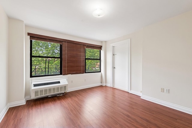 71-19 162nd St Unit 4E, Fresh Meadows, NY 11365 - spare room featuring wood finished floors, a wall mounted AC, and baseboards