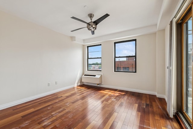 71-19 162nd St Unit 4E, Fresh Meadows, NY 11365 - empty room featuring hardwood / wood-style floors, baseboards, a ceiling fan, and a wall mounted air conditioner
