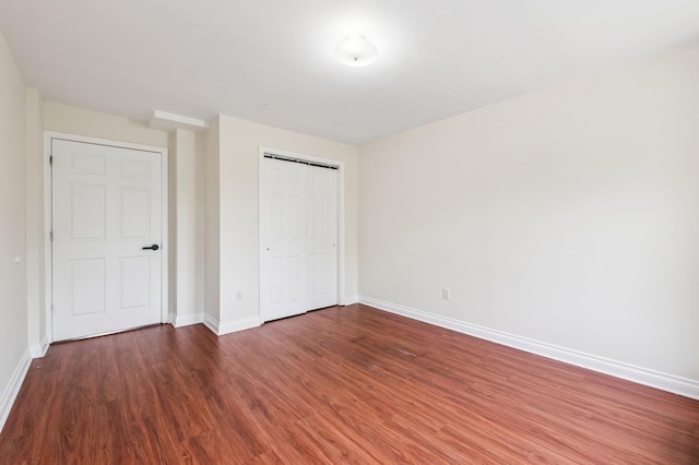 71-19 162nd St Unit 4E, Fresh Meadows, NY 11365 - unfurnished bedroom featuring baseboards, wood finished floors, and a closet