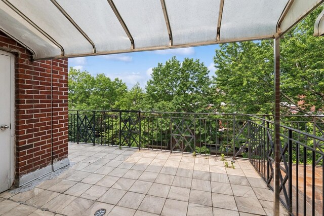 71-19 162nd St Unit 4E, Fresh Meadows, NY 11365 - view of patio featuring view of wooded area