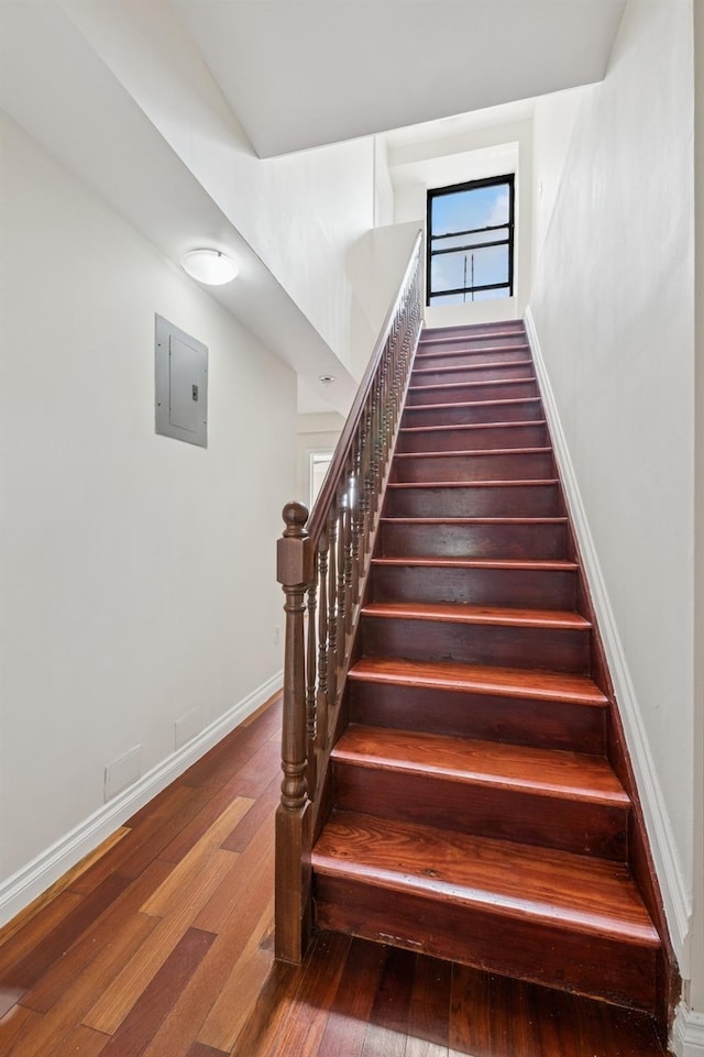 71-19 162nd St Unit 4E, Fresh Meadows, NY 11365 - staircase featuring wood finished floors, electric panel, and baseboards