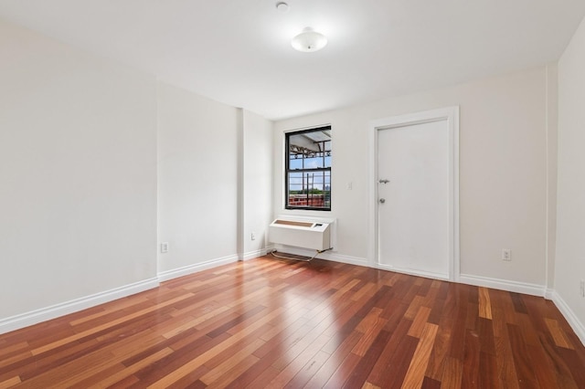 71-19 162nd St Unit 4E, Fresh Meadows, NY 11365 - unfurnished room featuring wood finished floors, a wall mounted AC, and baseboards
