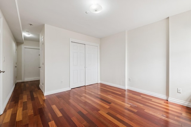 71-19 162nd St Unit 4E, Fresh Meadows, NY 11365 - unfurnished bedroom featuring wood finished floors, baseboards, and a closet