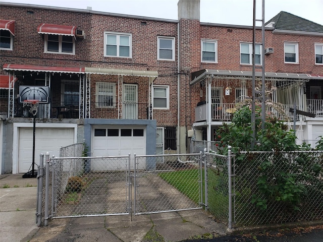 61-16 84th St, Middle Village, NY 11379 - view of front of home featuring driveway, an attached garage, brick siding, and a gate