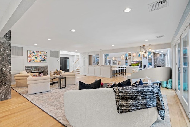 2 Field Ln, Roslyn Heights, NY 11577 - living room featuring wood finished floors, stairs, a high end fireplace, recessed lighting, and a chandelier